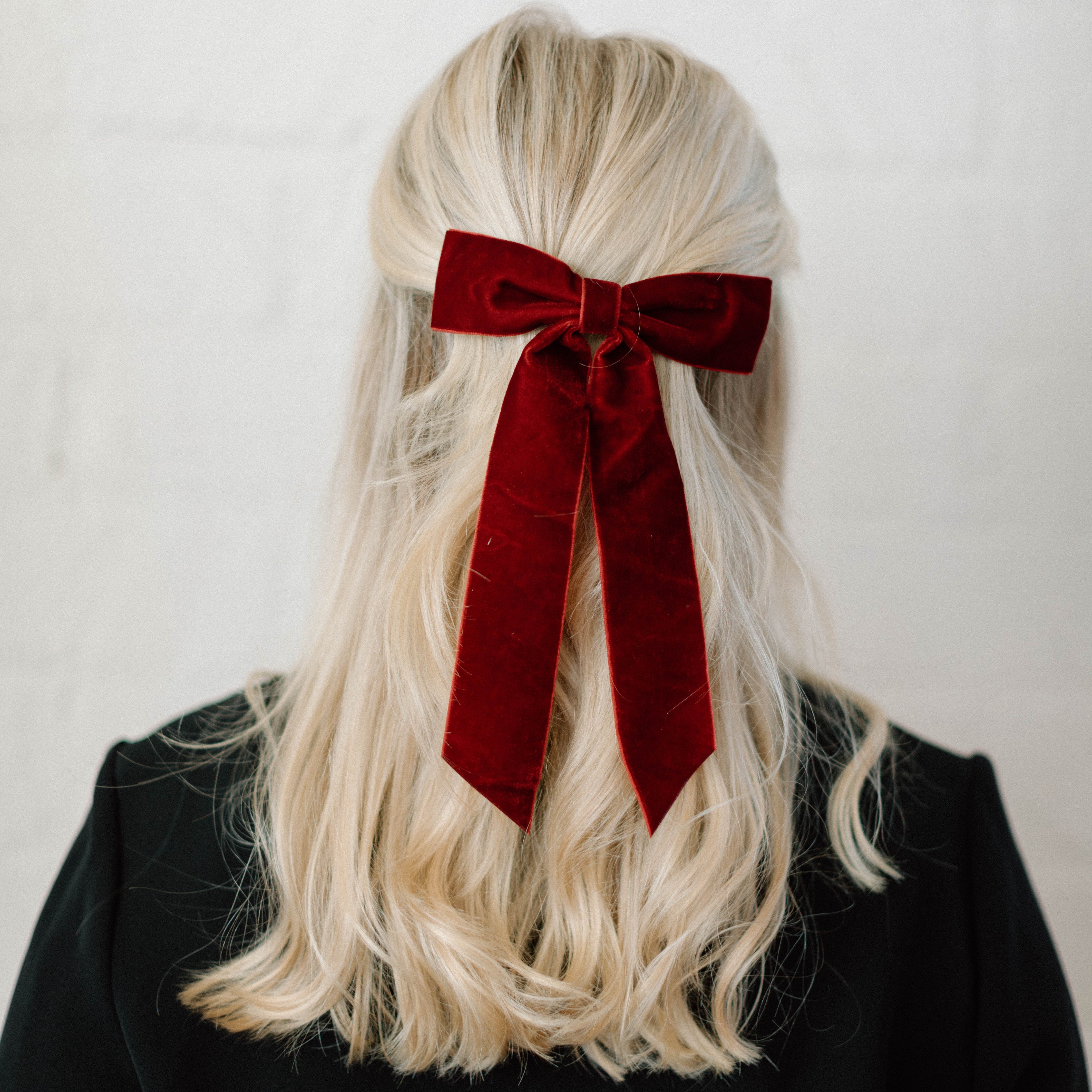 maroon bow clip in blonde hair