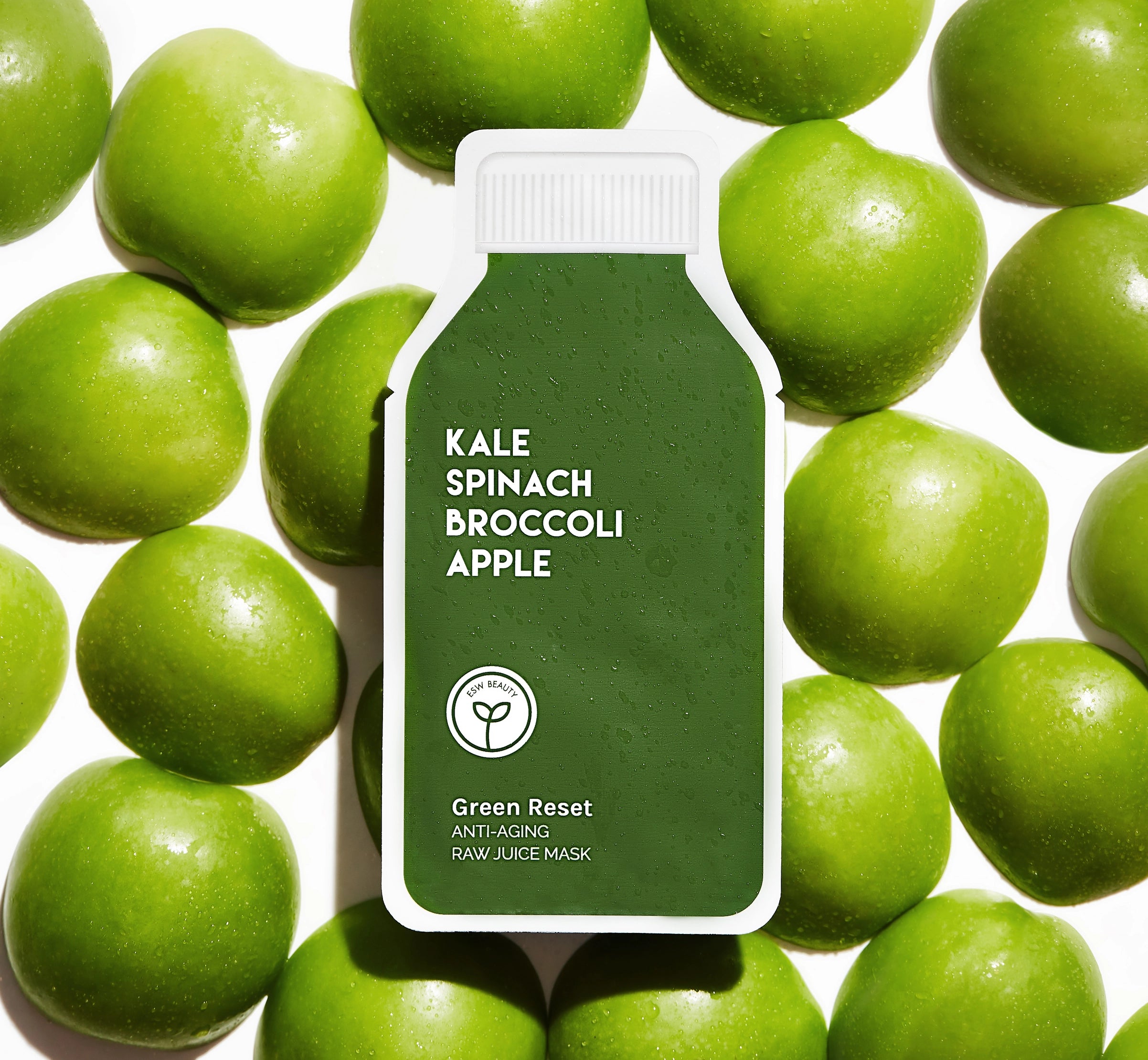 green sheet mask surrounded by apples