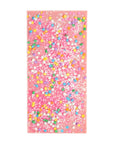 Pink towel with colorful confetti pattern on a white background