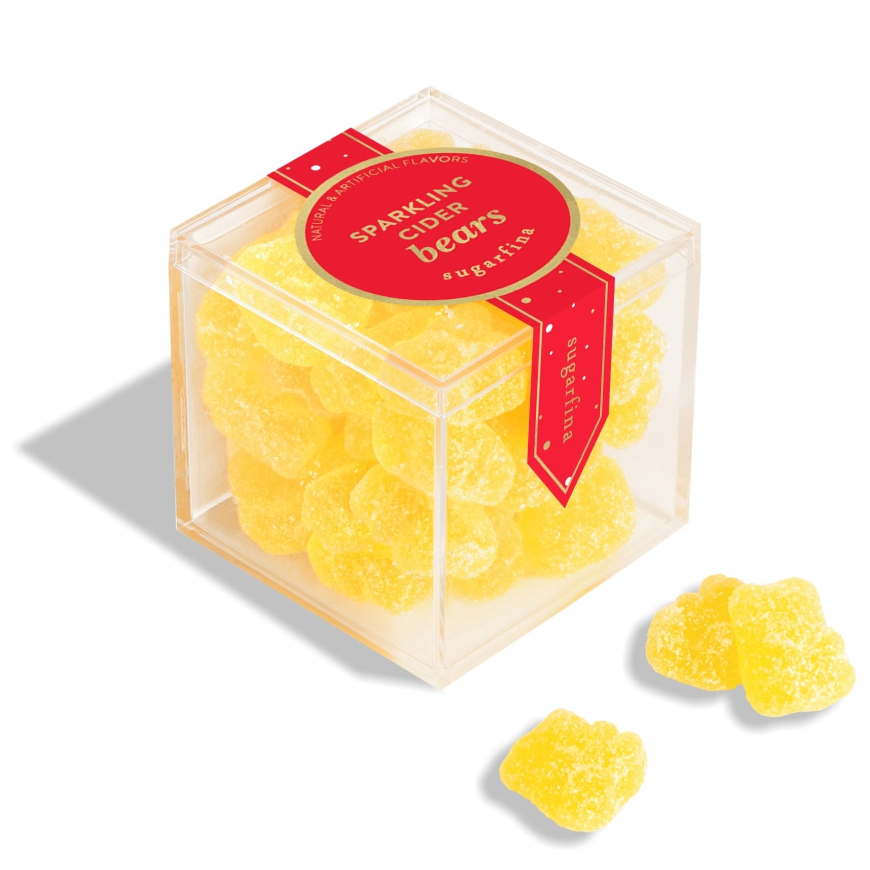 Clear cube container with yellow gummy bears and a red label on a white background