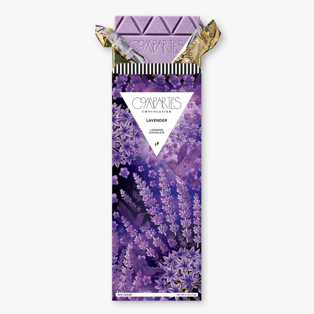 A lavender chocolate bar by Compâries Chocolates, featuring a purple floral wrapper with a triangular white label in the center and gold foil wrapping at the top, set against a plain light gray background.