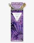 A lavender chocolate bar by Compâries Chocolates, featuring a purple floral wrapper with a triangular white label in the center and gold foil wrapping at the top, set against a plain light gray background.