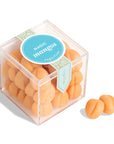 Clear cube container with 'Magic Mango' candies on a white background