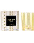 box with pink and gold design and a black label with gold writing that says "nest new york" and a gold candle 