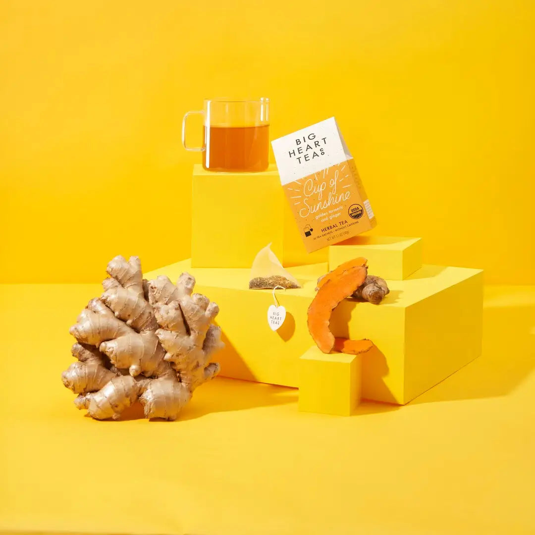 Tea packaging with a glass of tea and ginger root on a yellow background