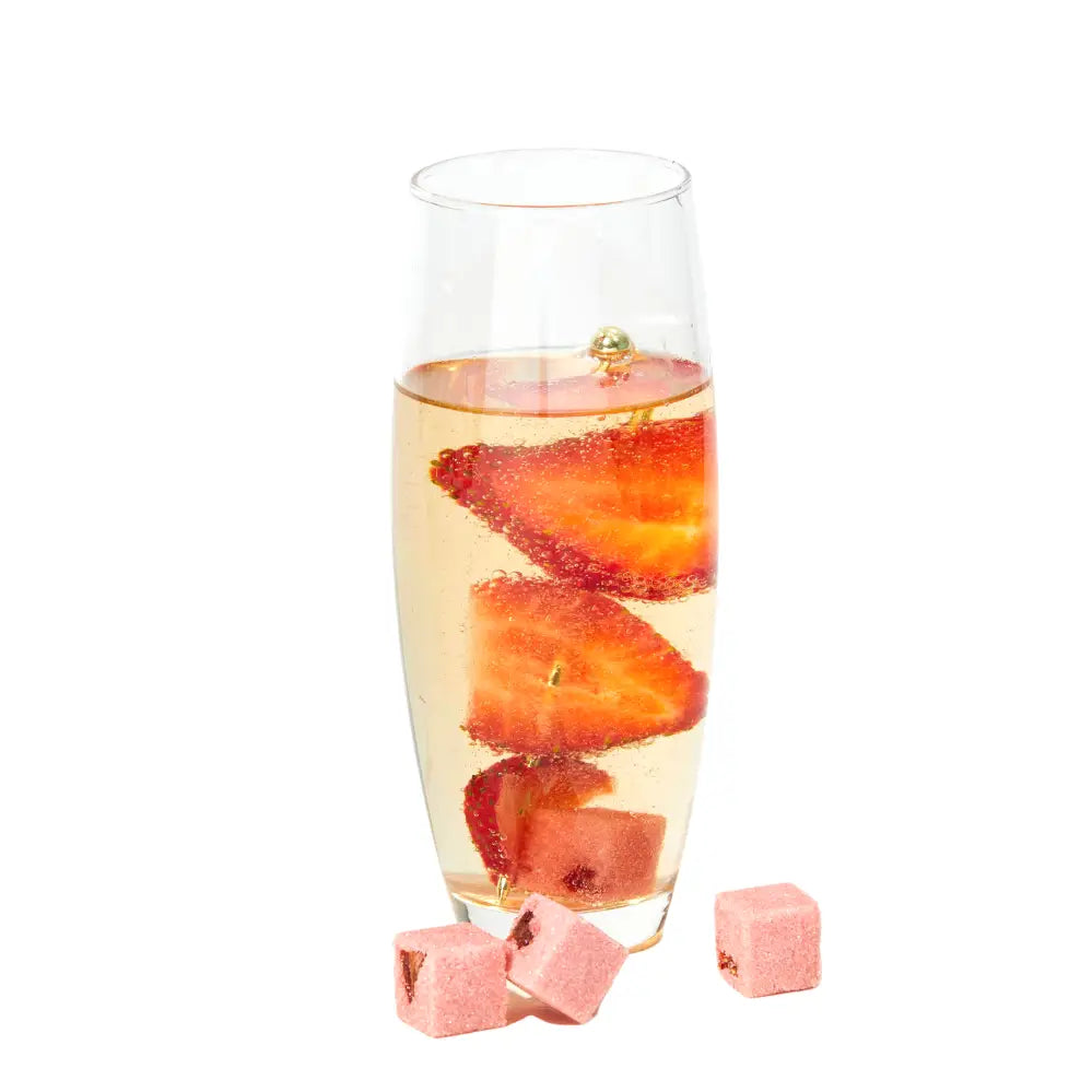 Glass of champagne with sliced strawberries on a white background