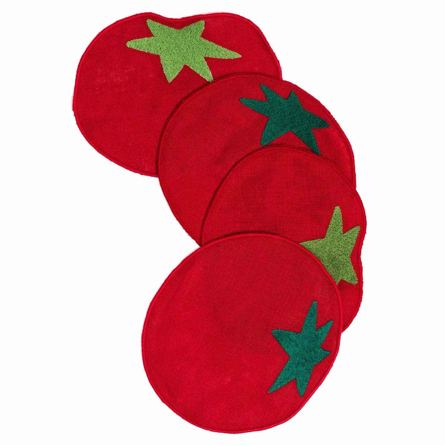 Set of red coasters with green star-like shapes on a white background