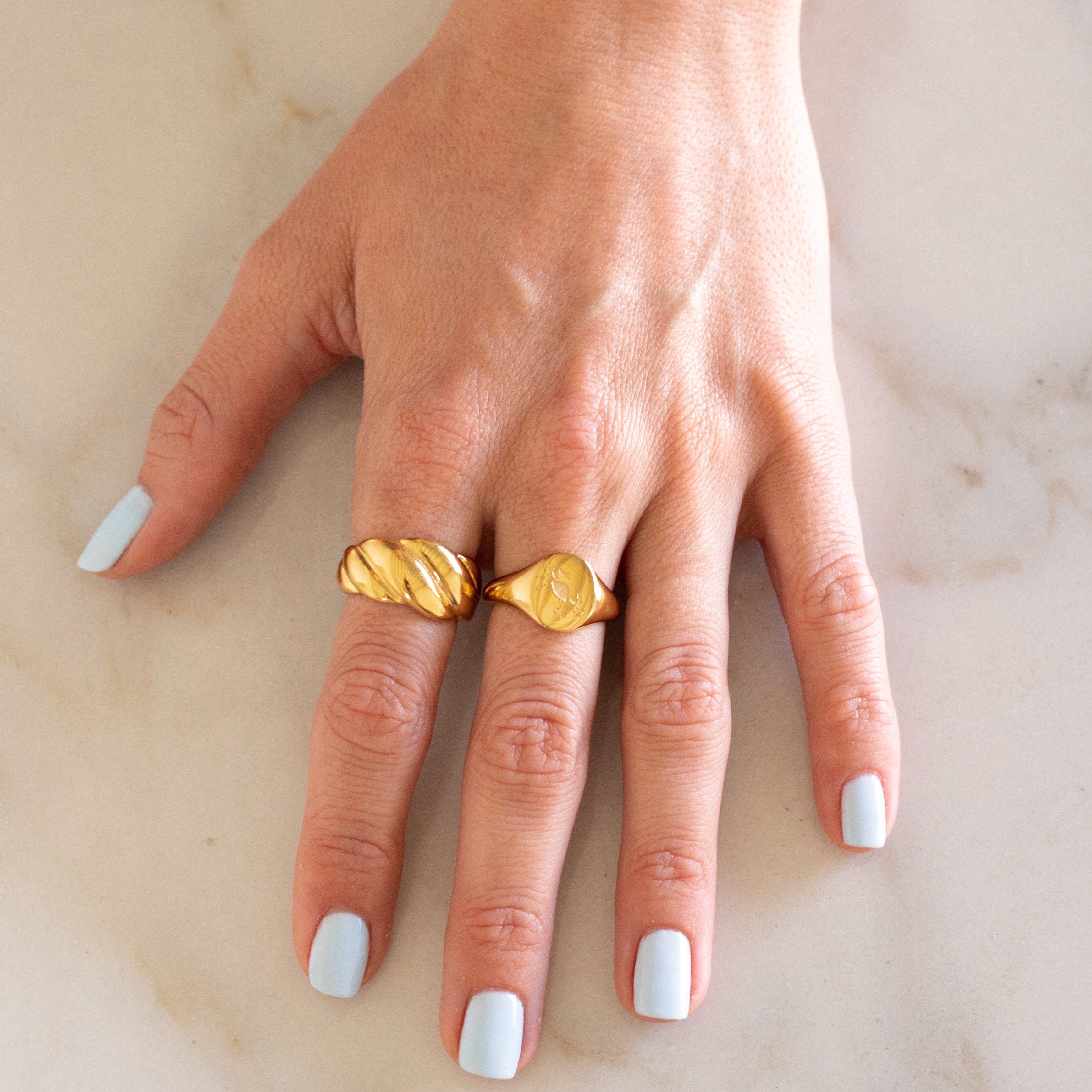 Hand with Gold Croissant Ring and Gold Cancer Ring