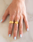 Hand wearing Gold Croissant Ring and Gold Cancer ring