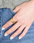 Hand wearing Gold Croissant Ring in denim pocket