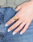 Hand wearing Gold Croissant Ring in denim pocket