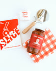  "Slice" Pizza book, wood pizza cutter, Ciao Pappy Marinara sauce, Pizza herbs jar and plaid red Geometry tea towel.