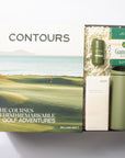 Gift set with 'Contours' book, tumbler, and golf tees on a white background