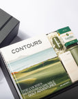 Golf-themed book titled 'Contours' with a green water bottle and other items on a white surface.