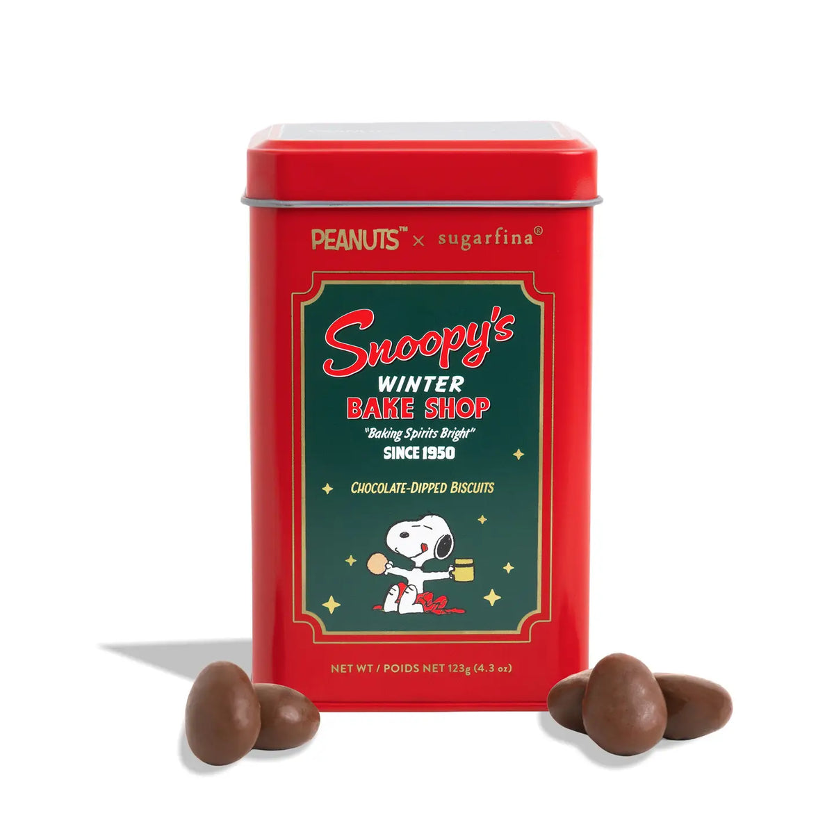 A red tin of Snoopy's Winter Bake Shop chocolate dipped biscuits, featuring the Peanuts x sugarfina branding and Snoopy artwork, with three chocolate biscuits displayed in front on a white background.