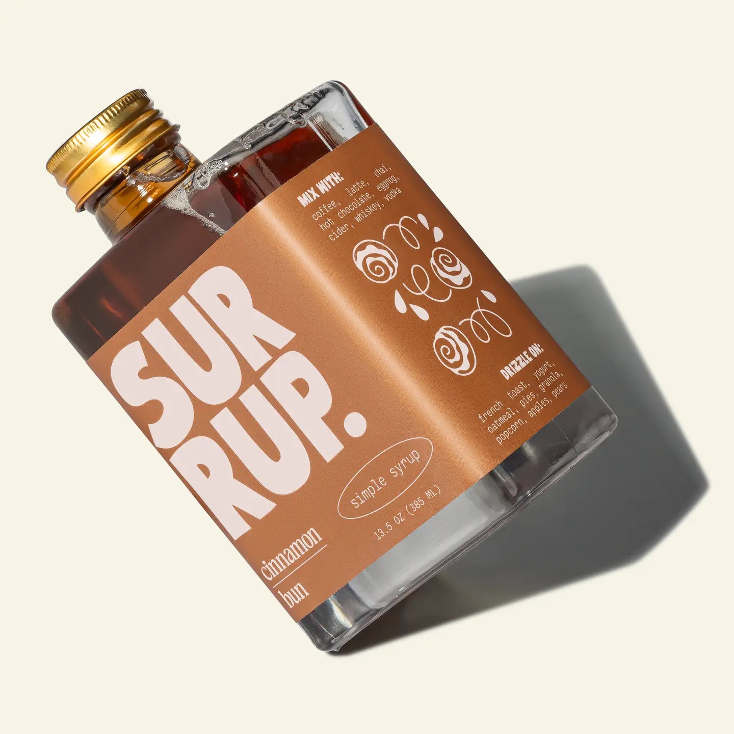 Bottle of Sur Rup syrup with a gold cap on a light background