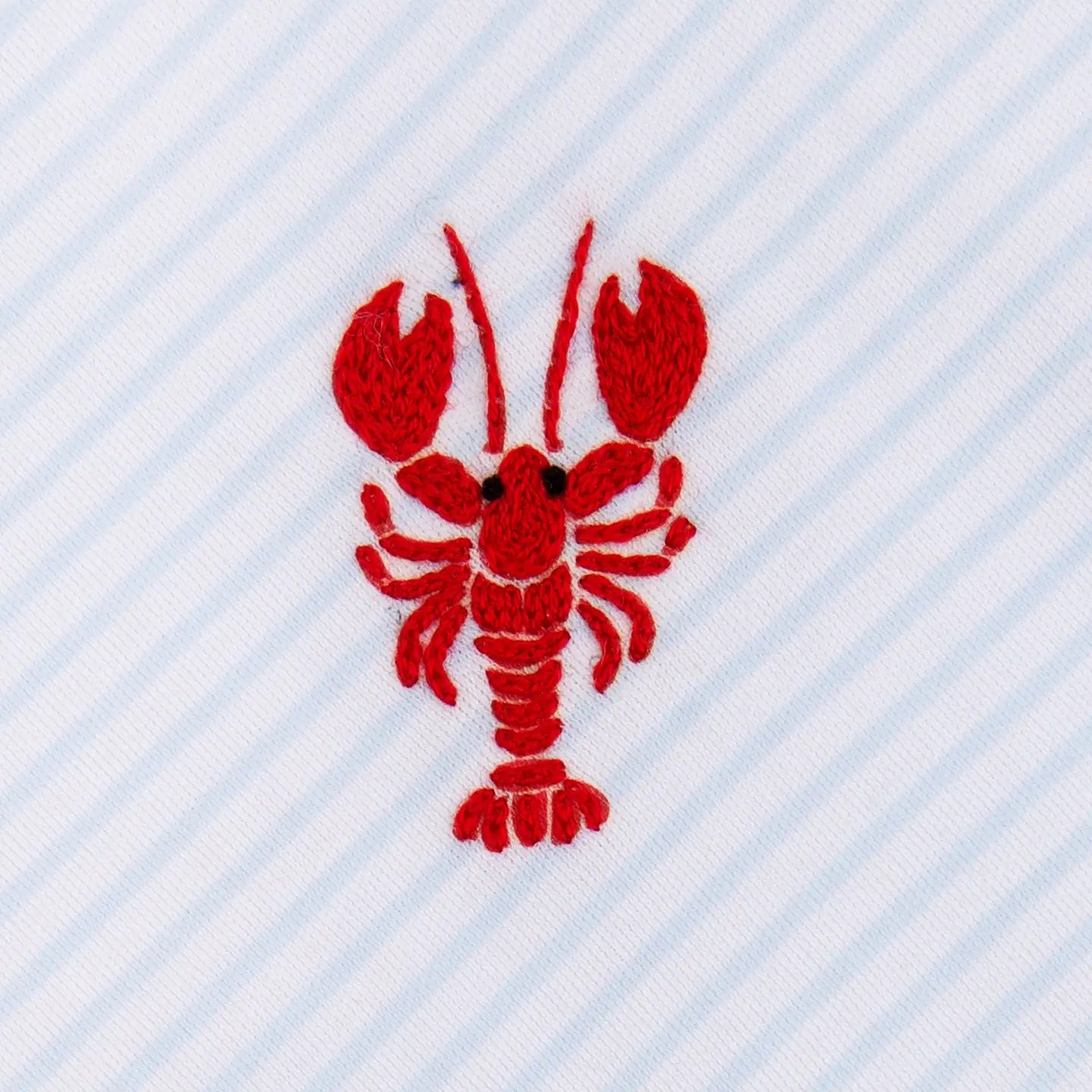 red lobster embroidery on a blue and white striped background
