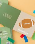 open football baby book surrounded by confetti