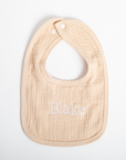 Beige baby bib with 'Blake' embroidered on a white background