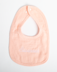 Pink baby bib with 'Sweetheart' embroidery on a white background