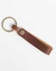 Brown leather keychain on a white background
