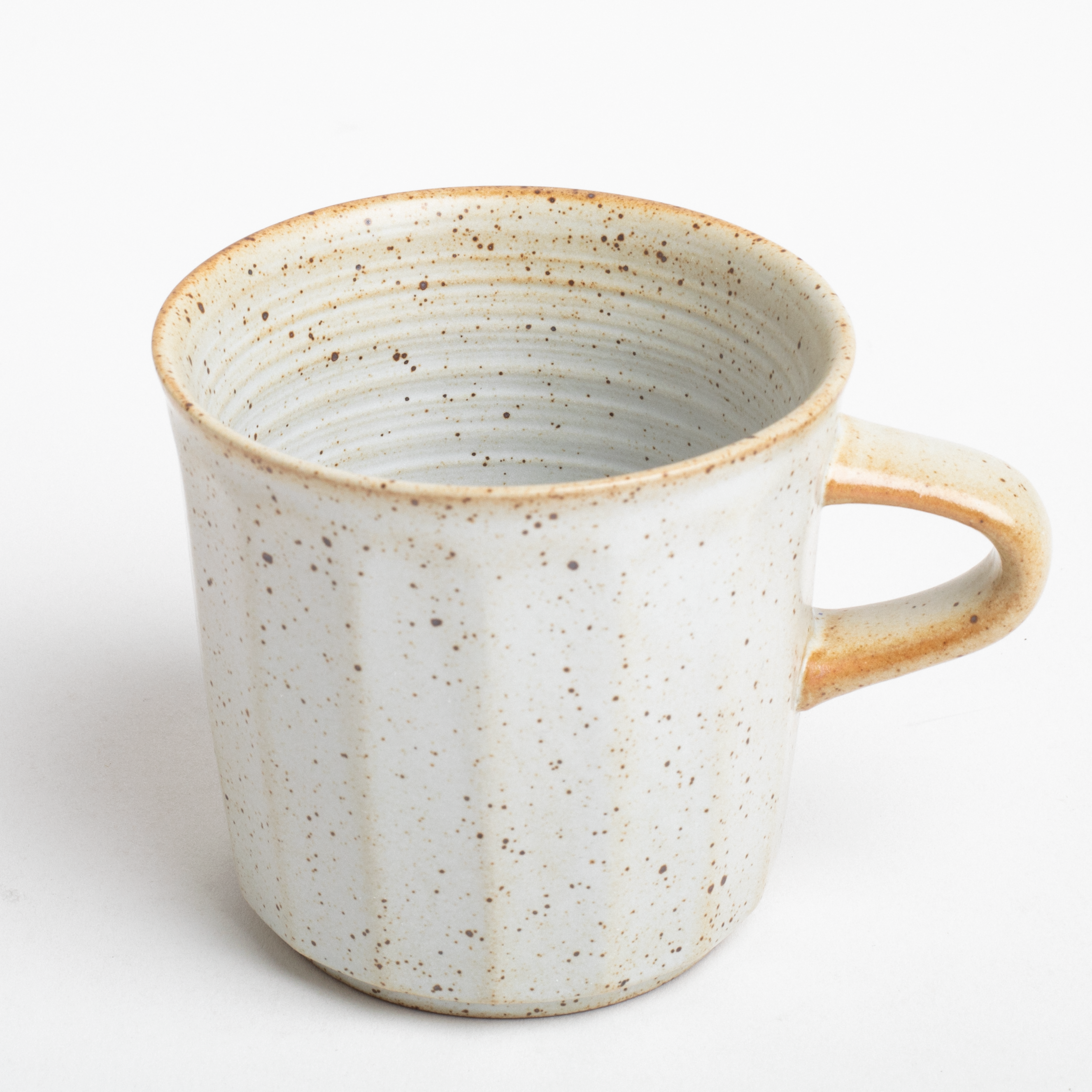 Speckled ceramic mug on a white background