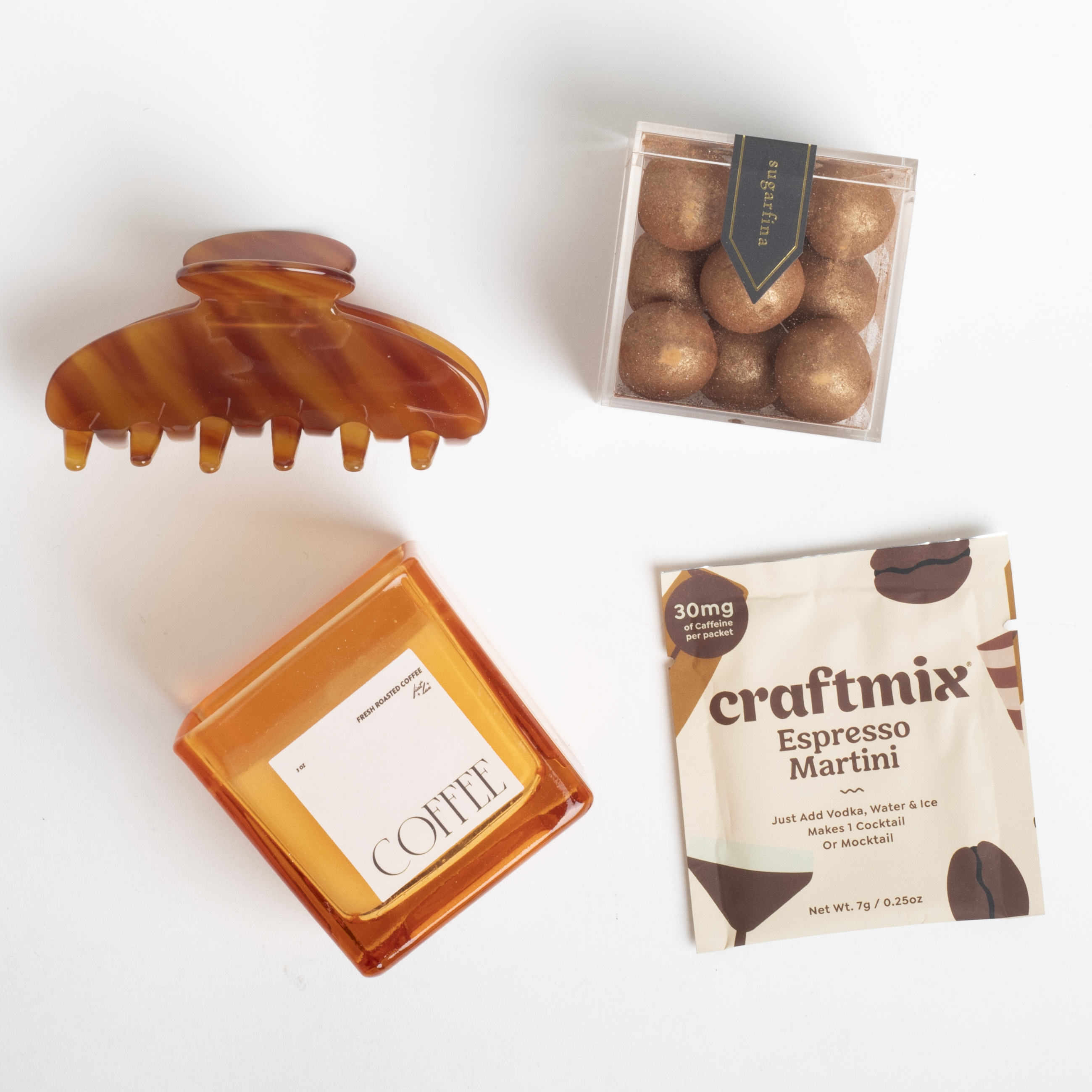 Tortoiseshell hair clip, coffee container, and craftmix Espresso Martini package on a white background
