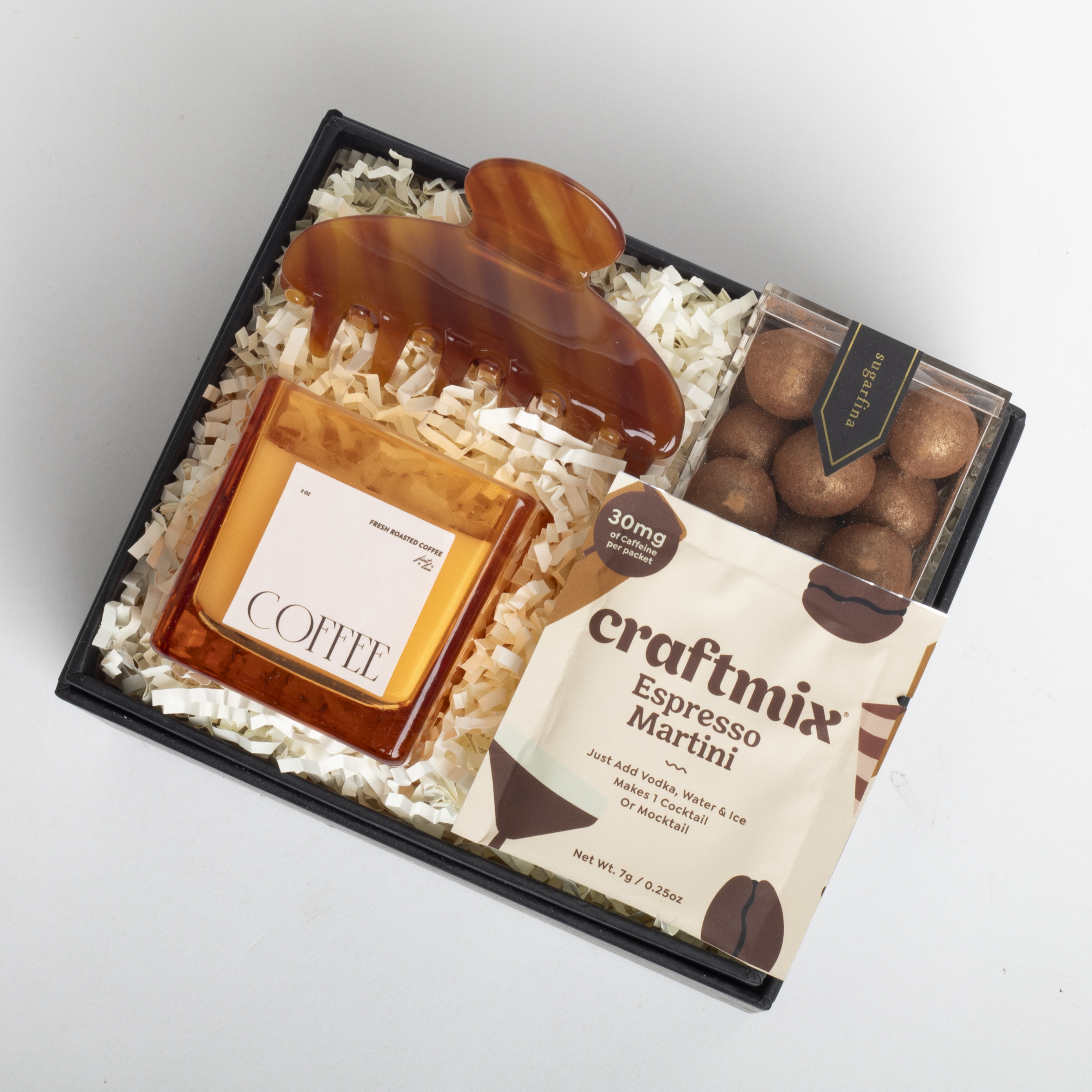 Gift set with coffee-themed items including a bottle and a box of craftmix Espresso Martini mix on a light gray background.