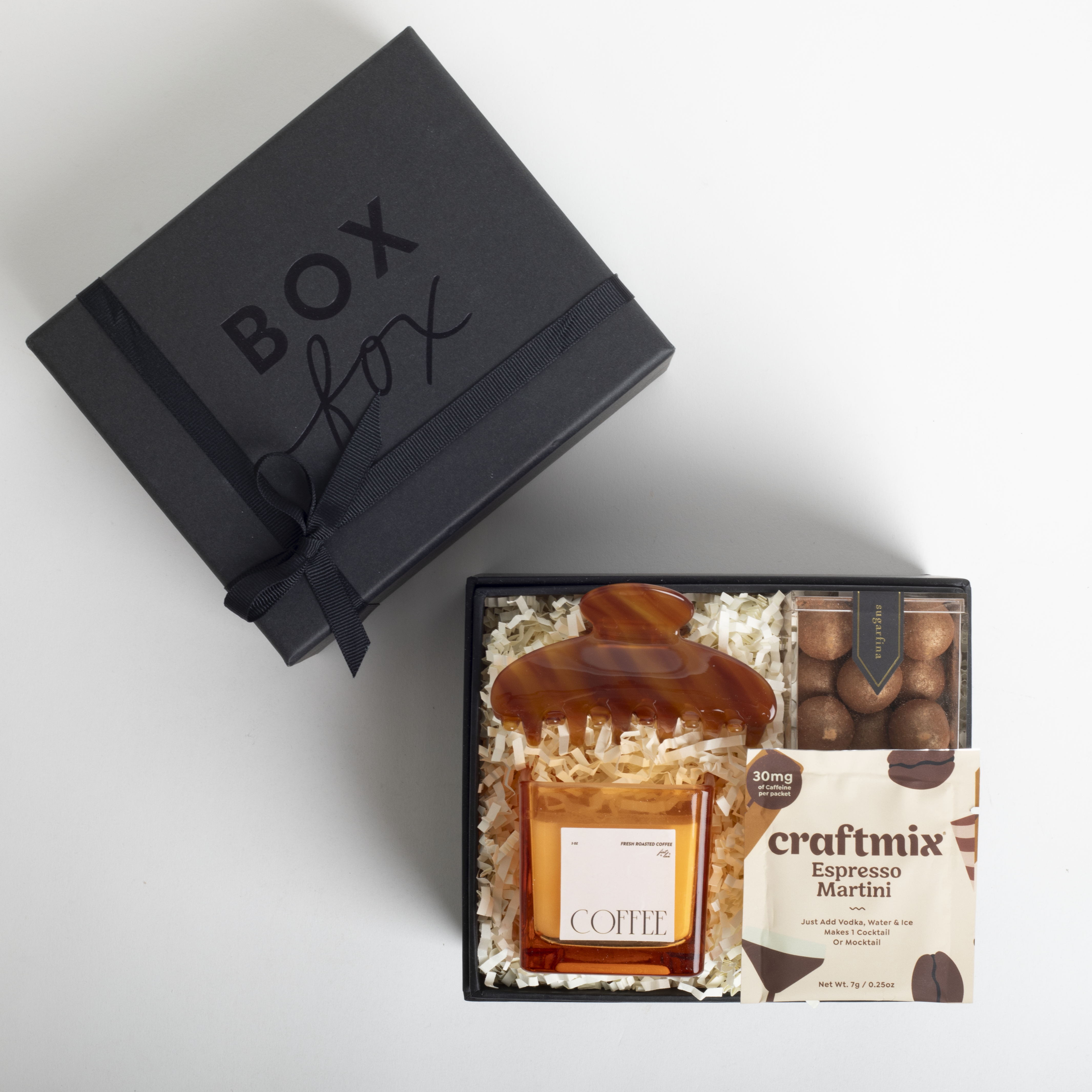 Gift set with coffee bottle, chocolate, and craft mix in a black 'Box Fox' box.