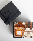 Gift set with coffee bottle, chocolate, and craft mix in a black 'Box Fox' box.