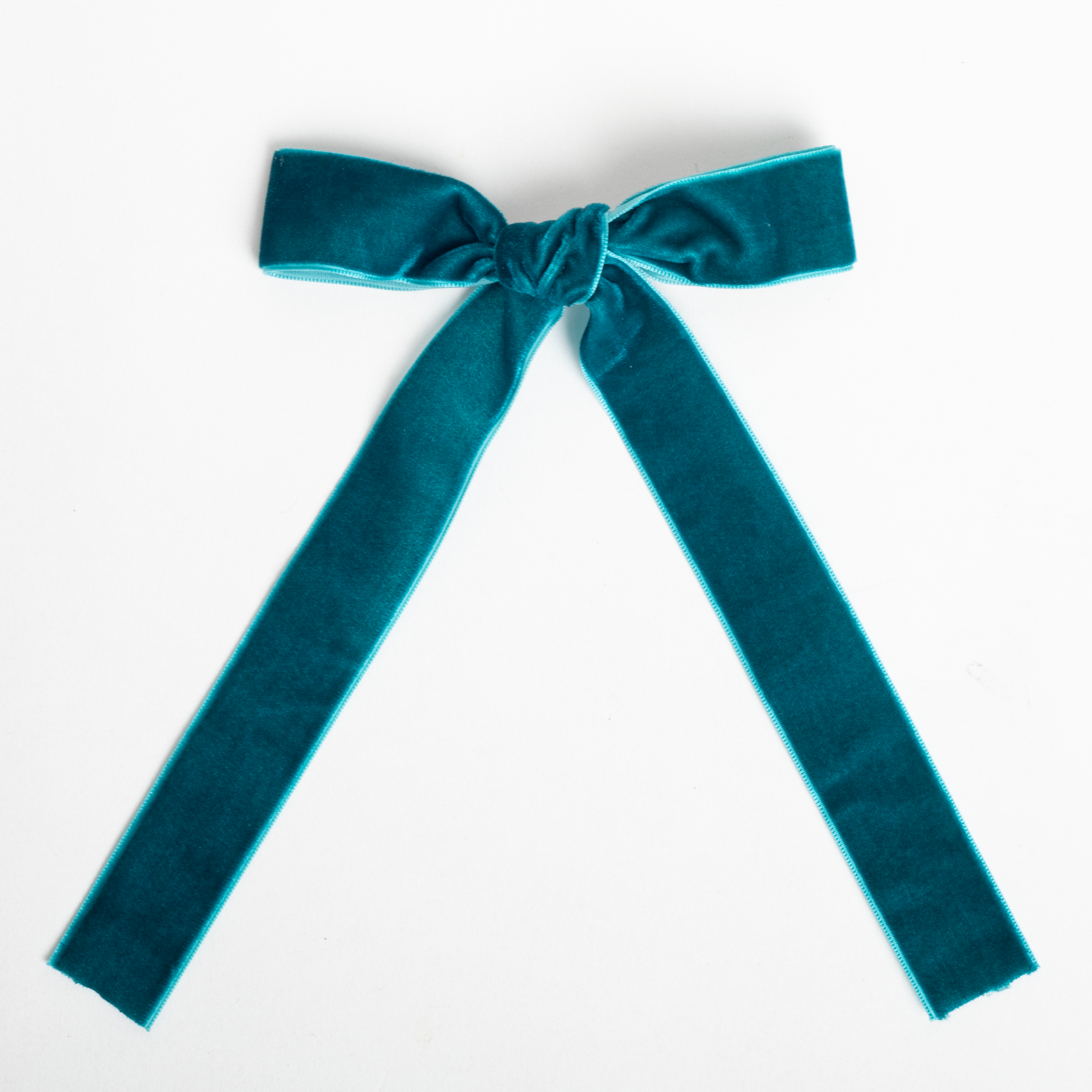 Teal velvet bow on a white background