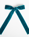 Teal velvet bow on a white background