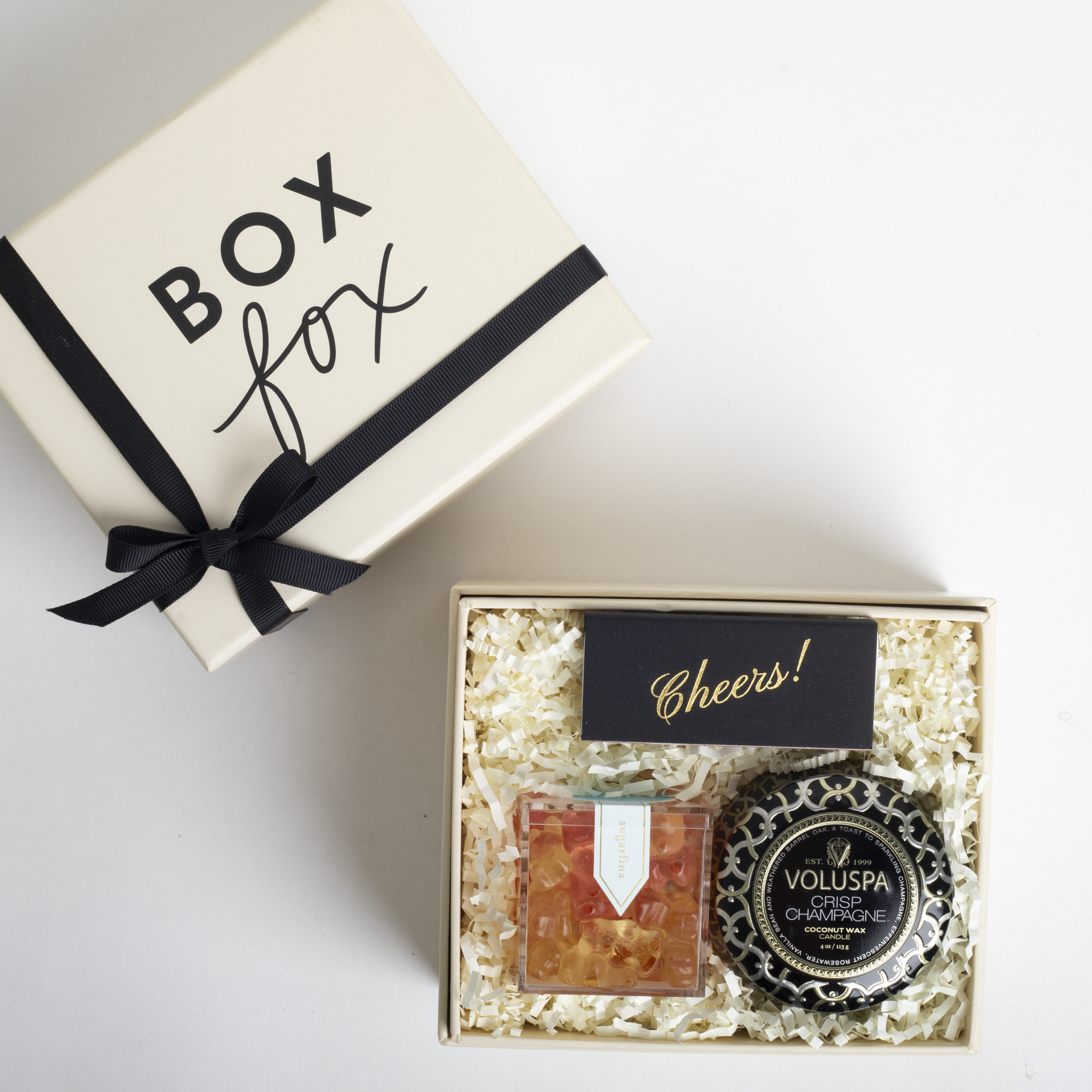 Gift set with Voluspa product and 'Box Fox' branded box on a white background