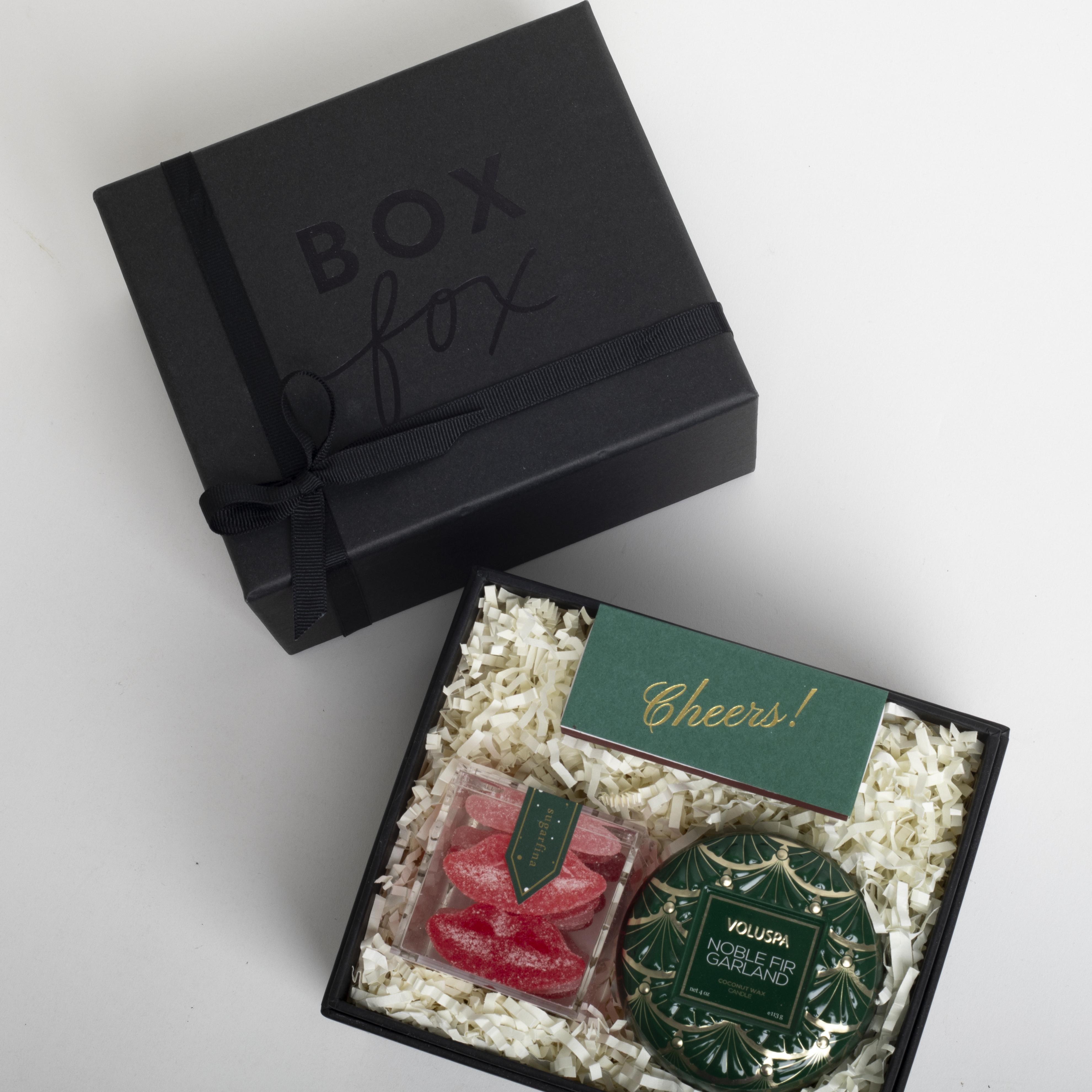 Gift box with 'Box Fox' branding, containing a card and two small containers on a white background.