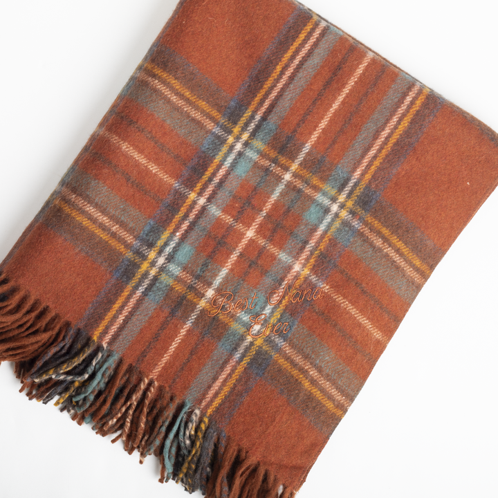 Plaid blanket with fringes on a white background