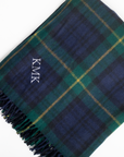 Plaid blanket with 'KMK' monogram on a white background