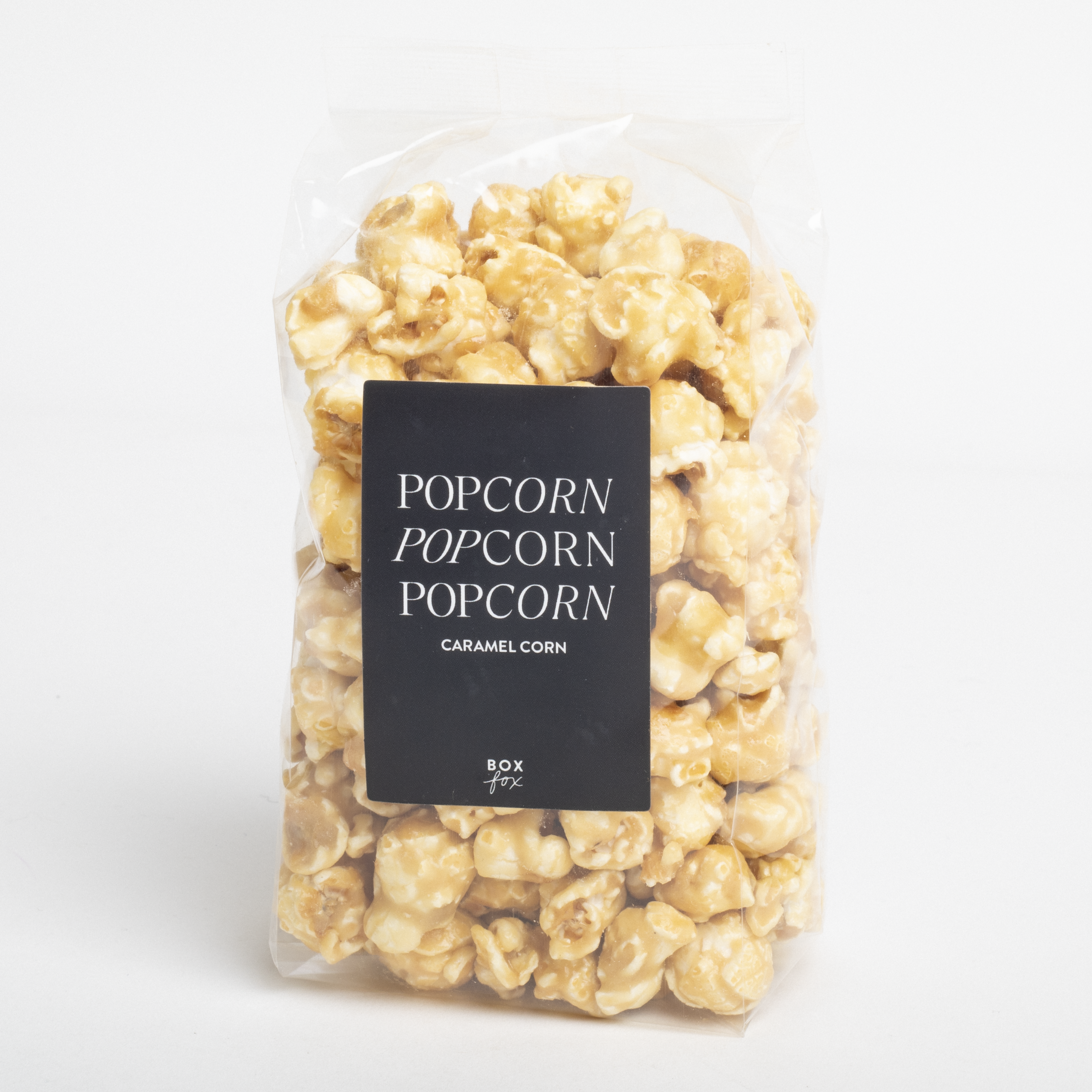 Packaged caramel popcorn with a label on a white background