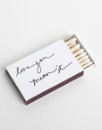 Matchbox with 'love you mean it' text on a white background