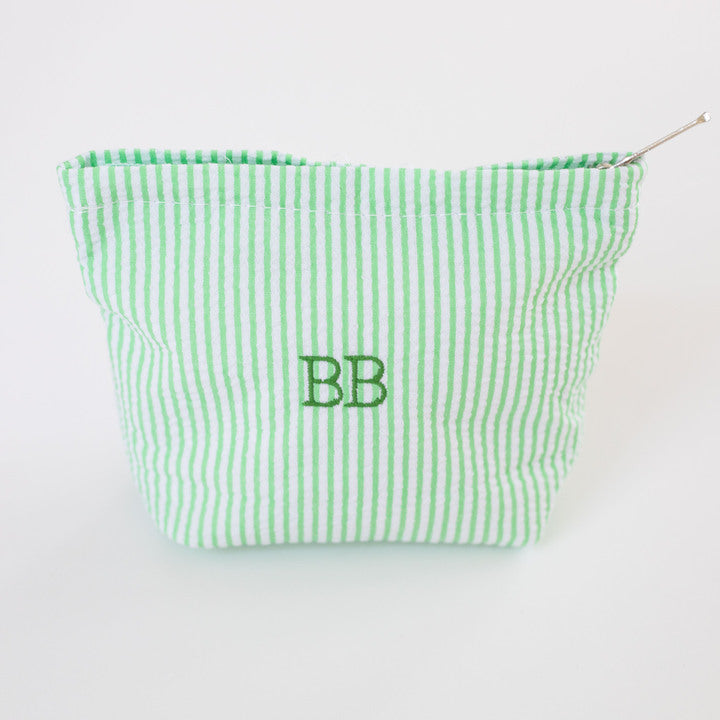 Green striped pouch with 'BB' monogram on a white background