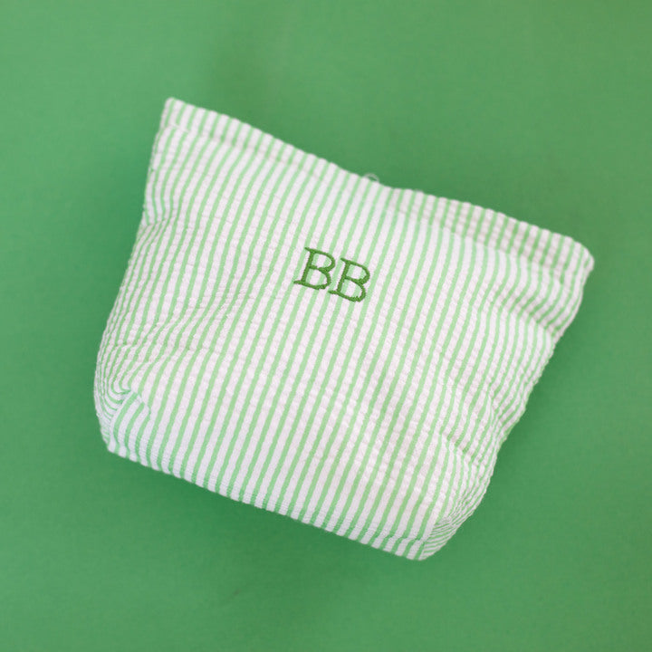 Green and white striped pouch with 'BB' monogram on a green background