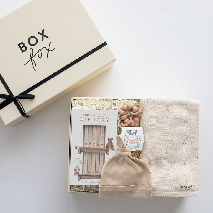 Baby hat, blanket, and book set with 'Box Fox' packaging on a white background