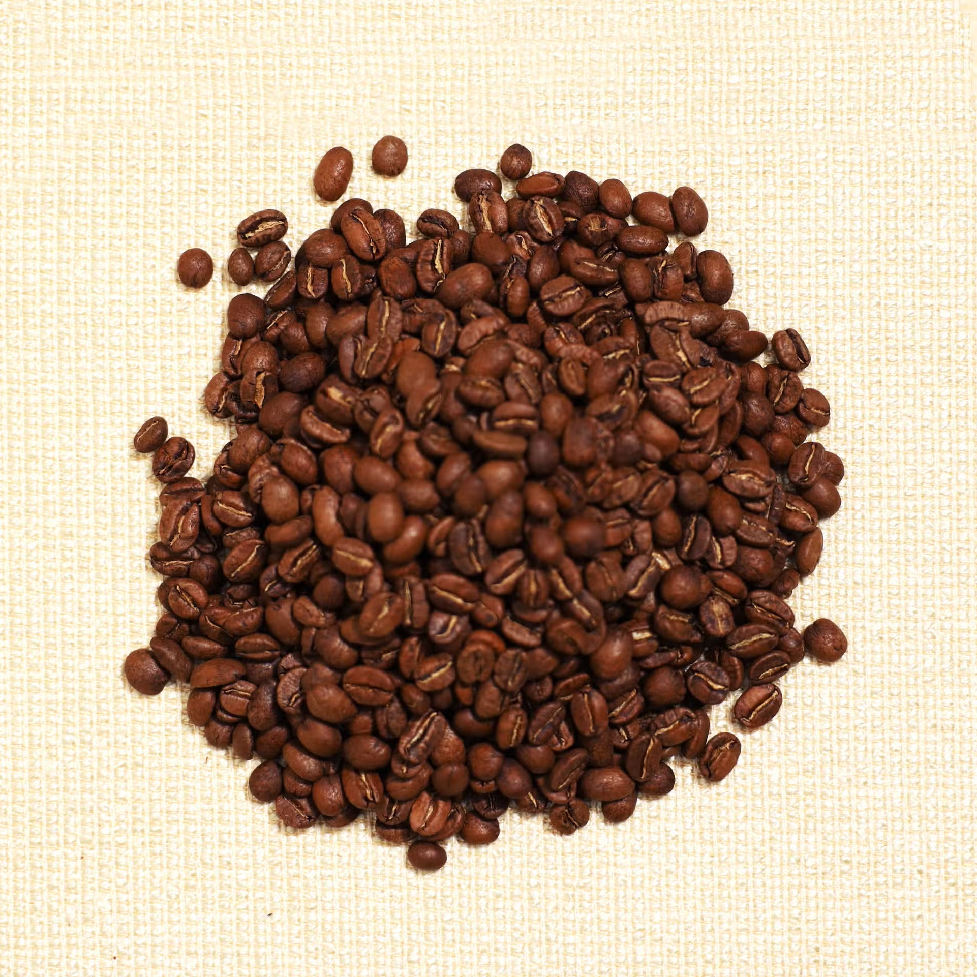 roasted coffee beans on yellow cloth