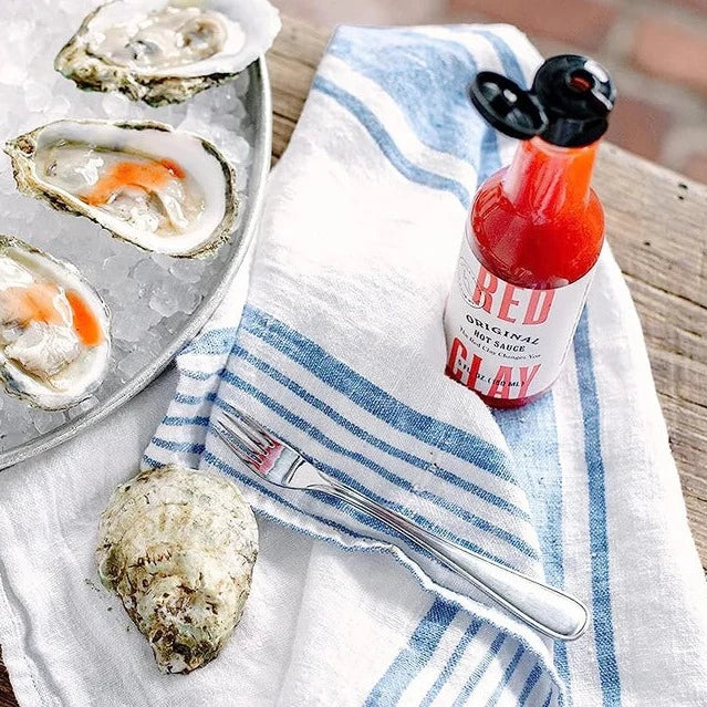 Original Hot Sauce next to oysters on ice
