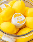 Body butter in a bowl of lemons