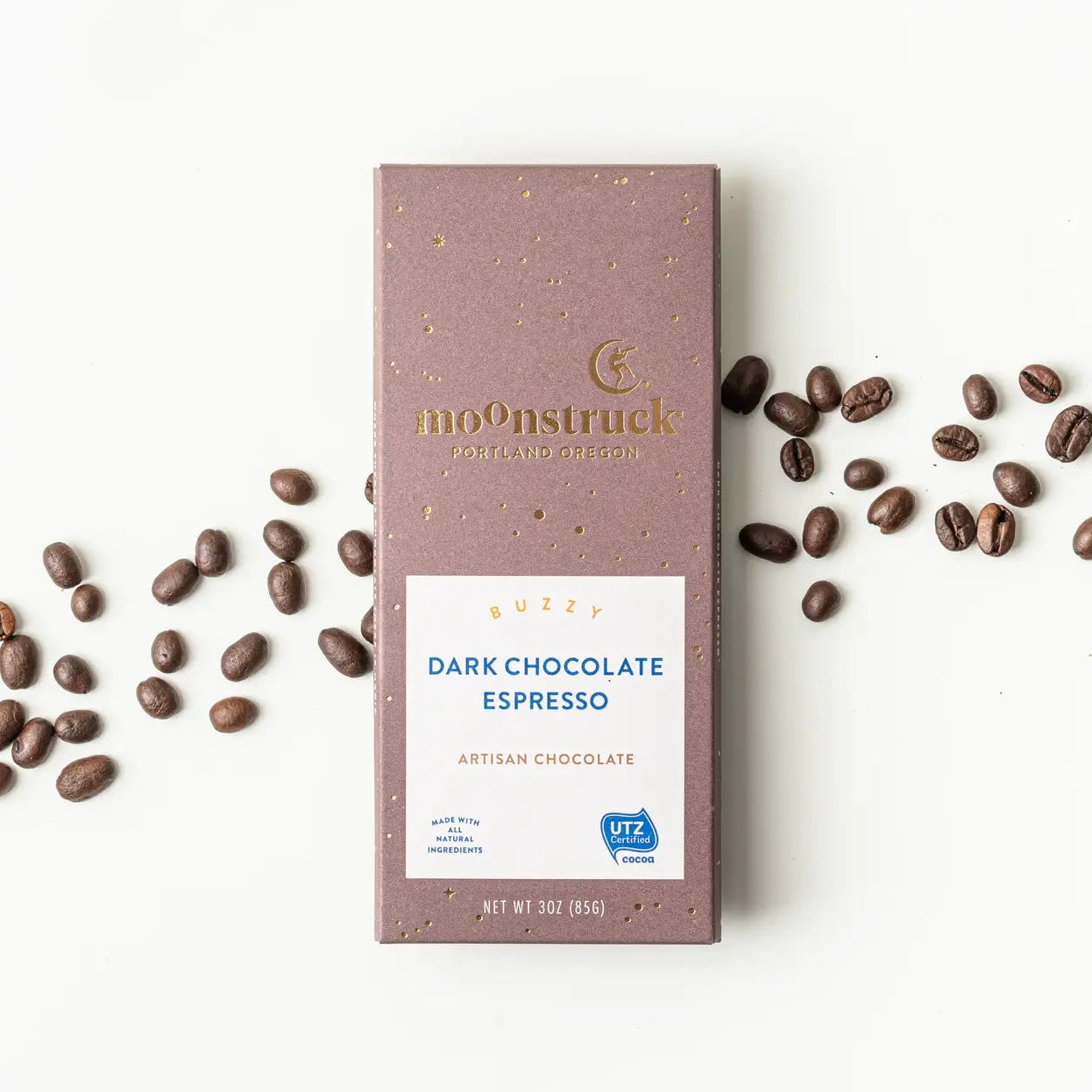 Moonstruck Dark Chocolate Espresso bar with coffee beans on a white background