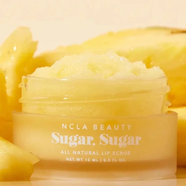 yellow lip scrub surrounded by pineapples