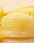 yellow lip scrub surrounded by pineapples