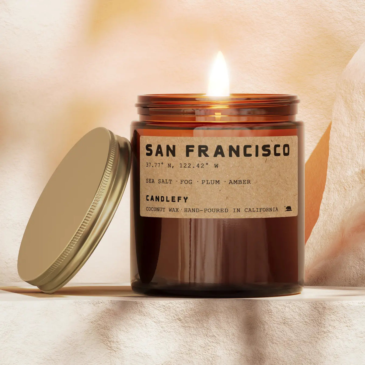 Candle with a label on a soft, neutral background