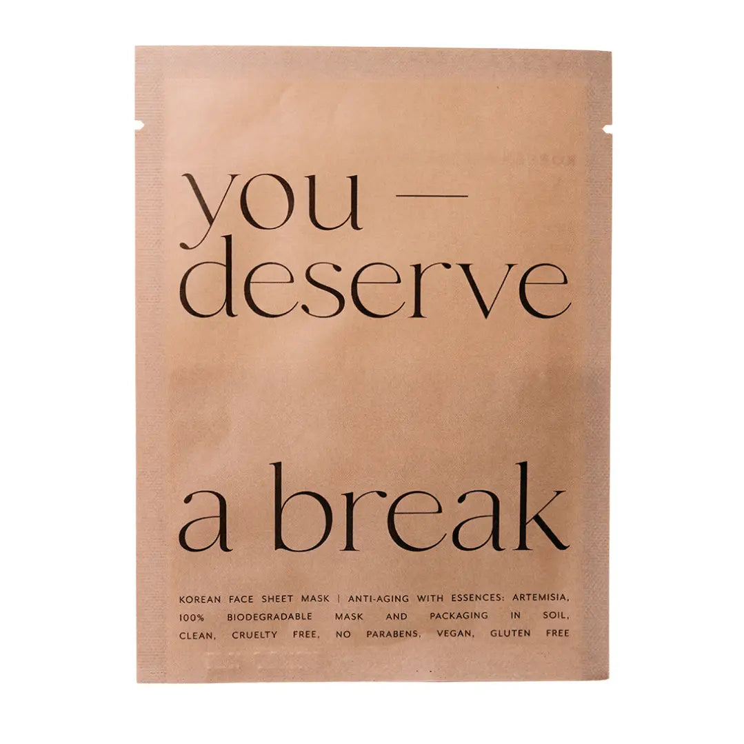 Kraft paper face mask packaging with 'you deserve a break' text on a white background