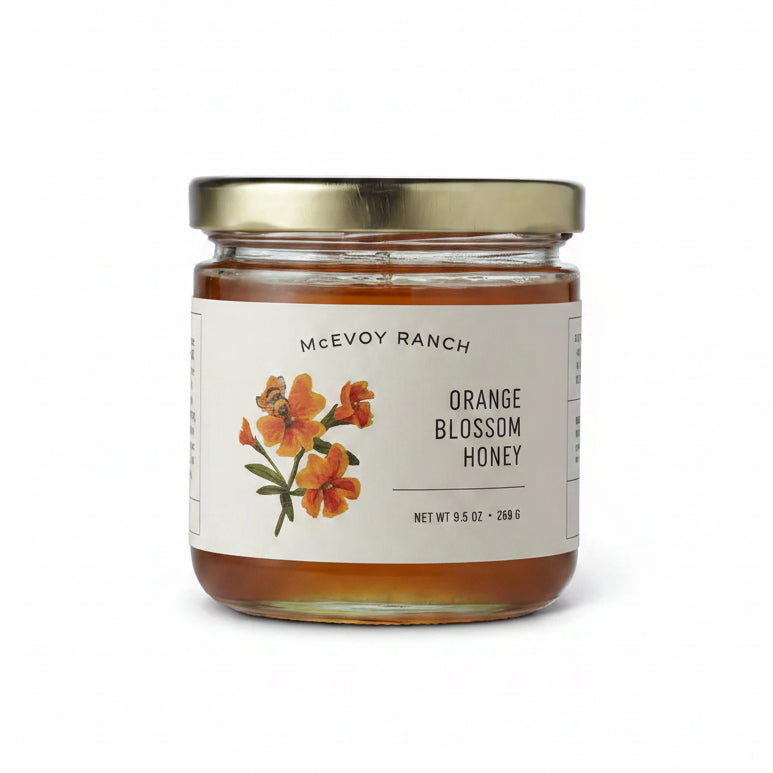 Jar of Mcevoy Ranch Orange Blossom Honey on a white background